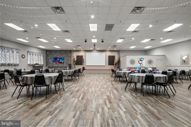 a room with lots of furniture and wooden floor