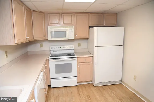 a kitchen with a refrigerator and a stove