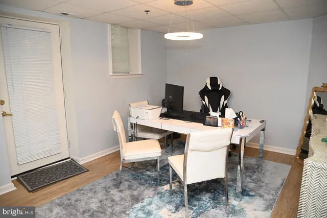 a living room with furniture and a piano table