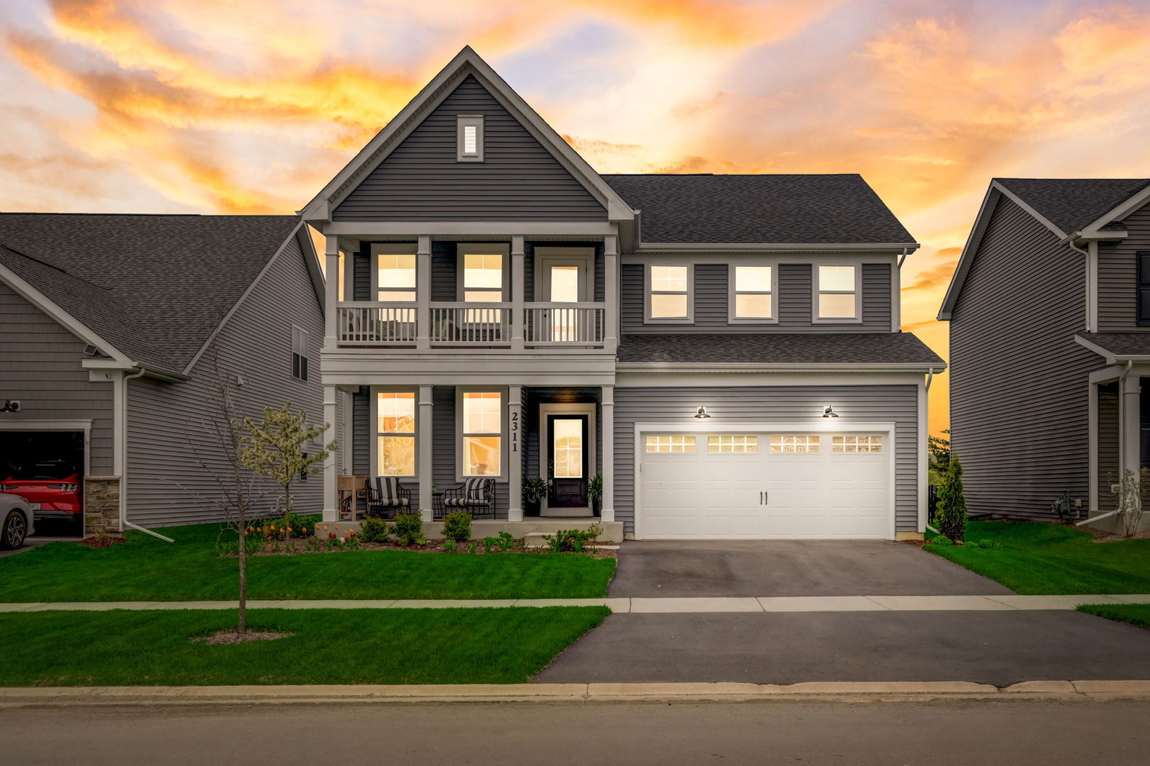 a front view of a house with a yard and garage