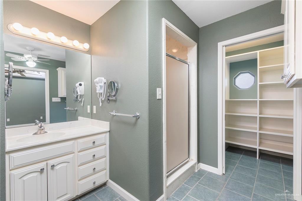 100 West Moore Road, Unit UT1 Pharr, TX 78577 - Photo 11 of 21 Step in shower, a walk in closet with ample storage shelves
