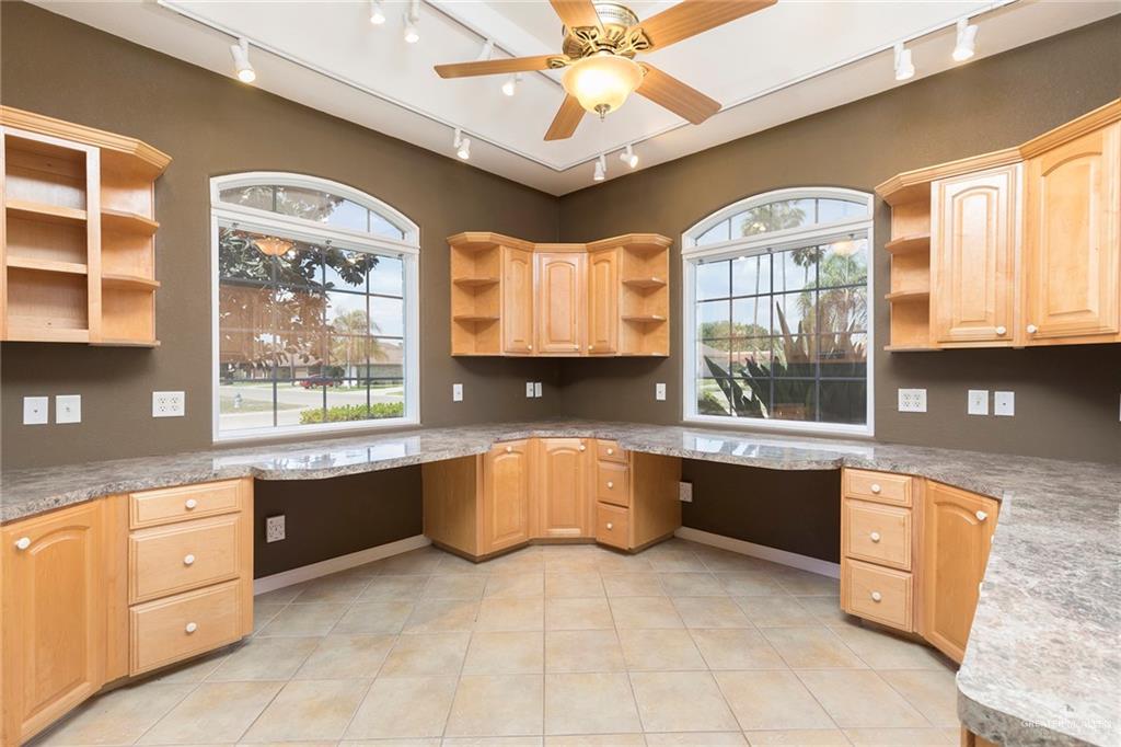 100 West Moore Road, Unit UT1 Pharr, TX 78577 - Photo 13 of 21 Dedicated office/study featuring track lighting, open shelves, built in desk, light wood finish cabinetry, and ceiling fan