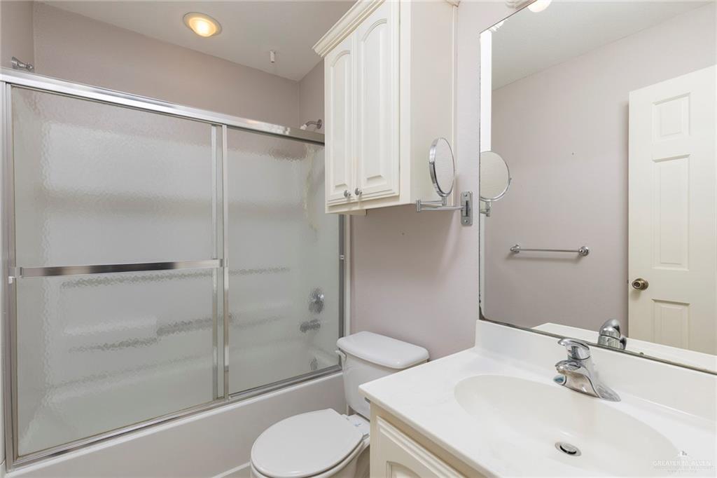 100 West Moore Road, Unit UT1 Pharr, TX 78577 - Photo 15 of 21 Full guest bathroom featuring vanity and shower / bath combination with glass door