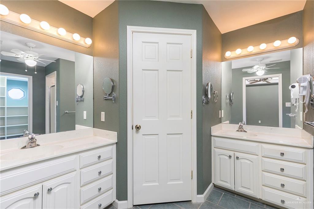 100 West Moore Road, Unit UT1 Pharr, TX 78577 - Photo 10 of 21 Primary Bathroom featuring double vanities, built-ins and dark tile patterned floors