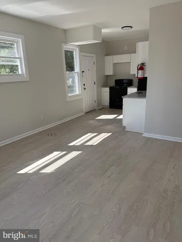 a view of a kitchen with microwave and cabinets