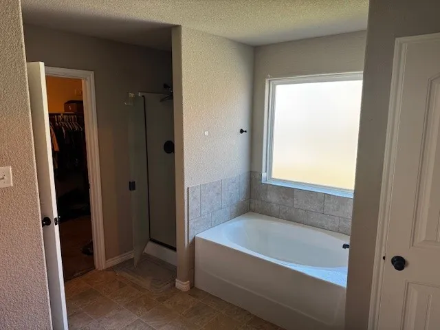 a bathroom with a bathtub and a shower