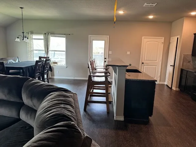 a view of living room with furniture and wooden floor