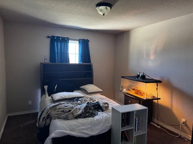 a bedroom with a bed and a table in it