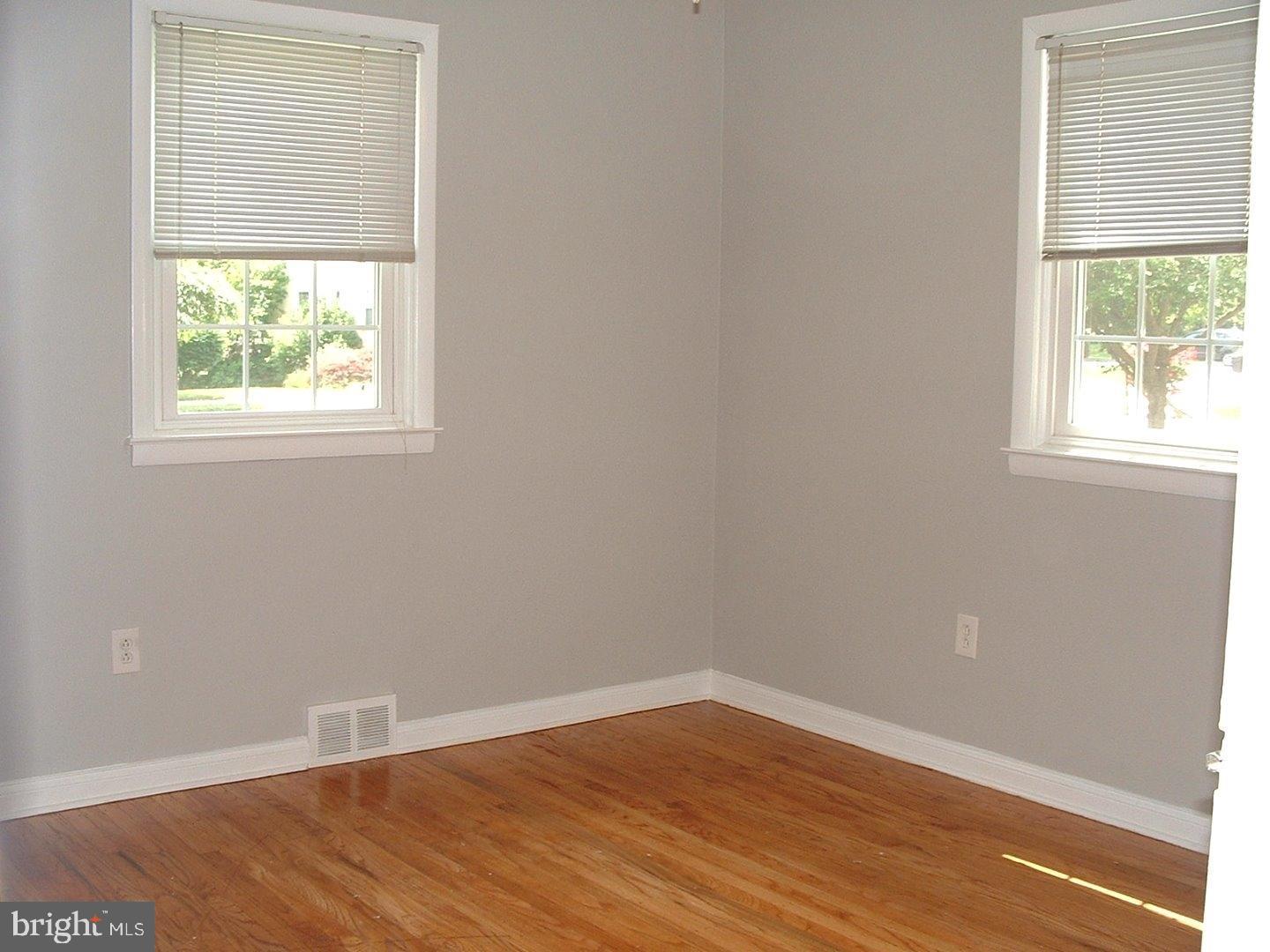 110 Barren Road Newtown Square, PA 19073 - Photo 11 of 15 an empty room with wooden floor and windows