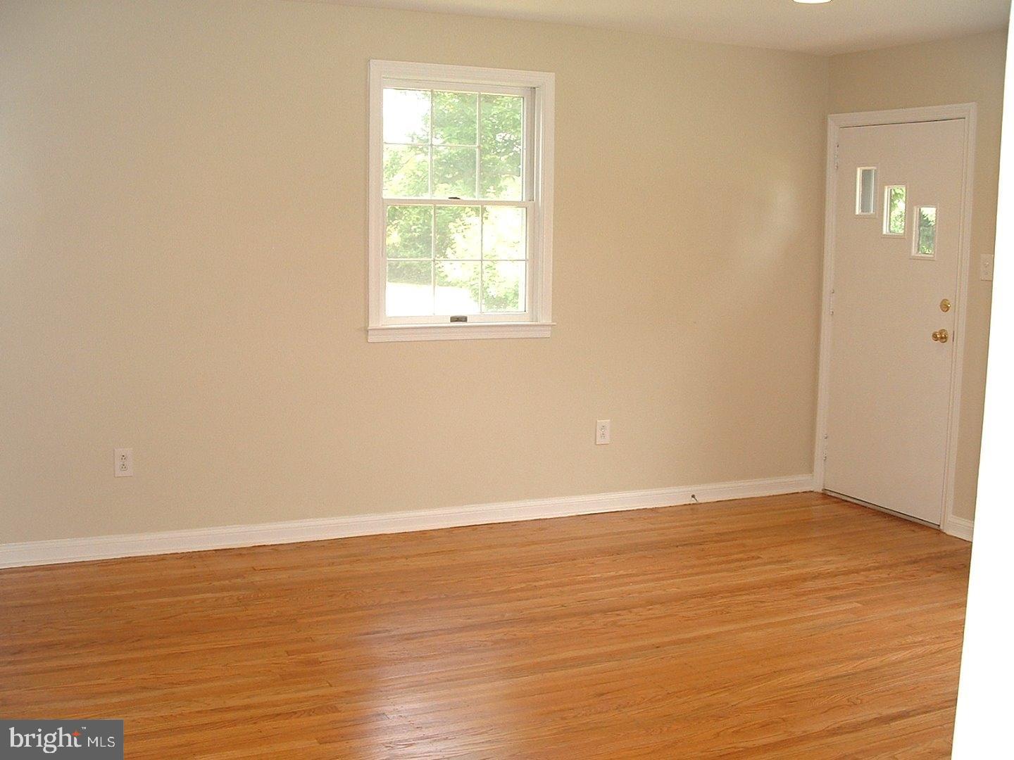 110 Barren Road Newtown Square, PA 19073 - Photo 6 of 15 an empty room with wooden floor and windows