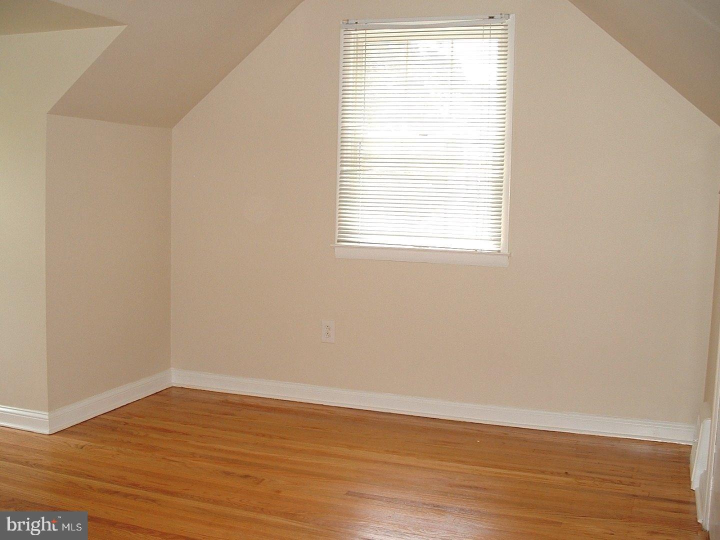 110 Barren Road Newtown Square, PA 19073 - Photo 10 of 15 a view of an empty room with wooden floor and a window