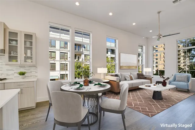 a view of a dining room with furniture a couch and wooden floor