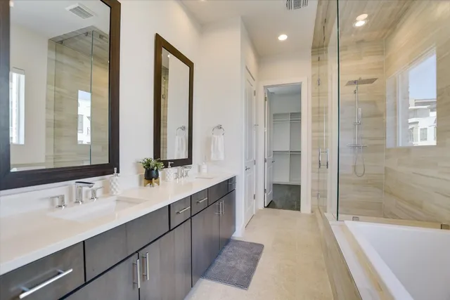 a bathroom with a double vanity sink and a mirror