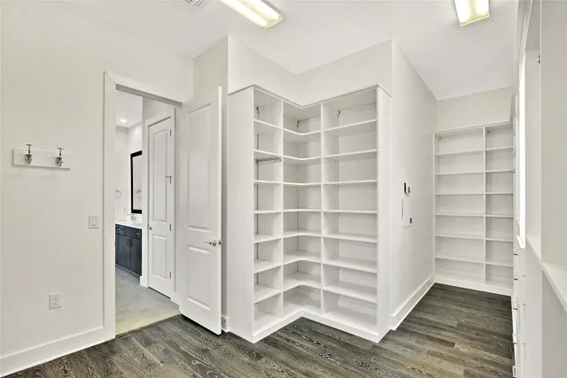 a view of walk in closet with empty racks
