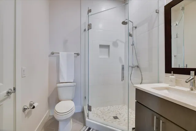 a bathroom with a sink toilet and shower