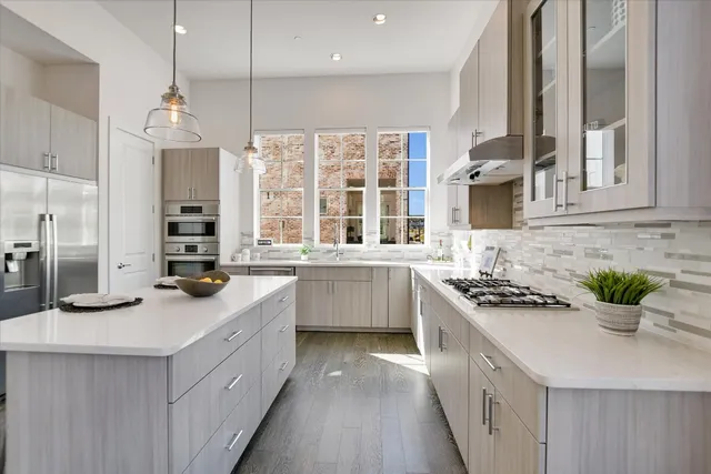 a kitchen with stainless steel appliances a sink stove and cabinets