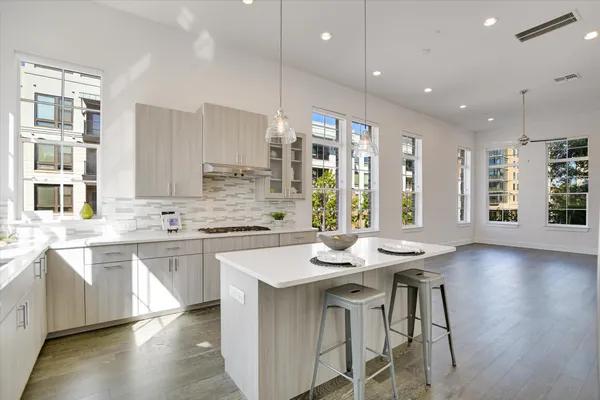a kitchen with counter space sink and chairs