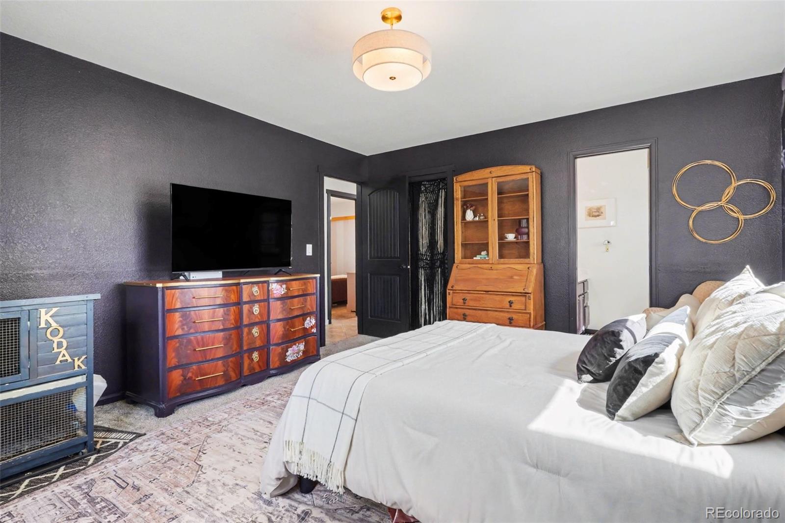 38 Pinon Road Bailey, CO 80421 - Photo 12 of 26 a bedroom with a bed and a flat screen tv