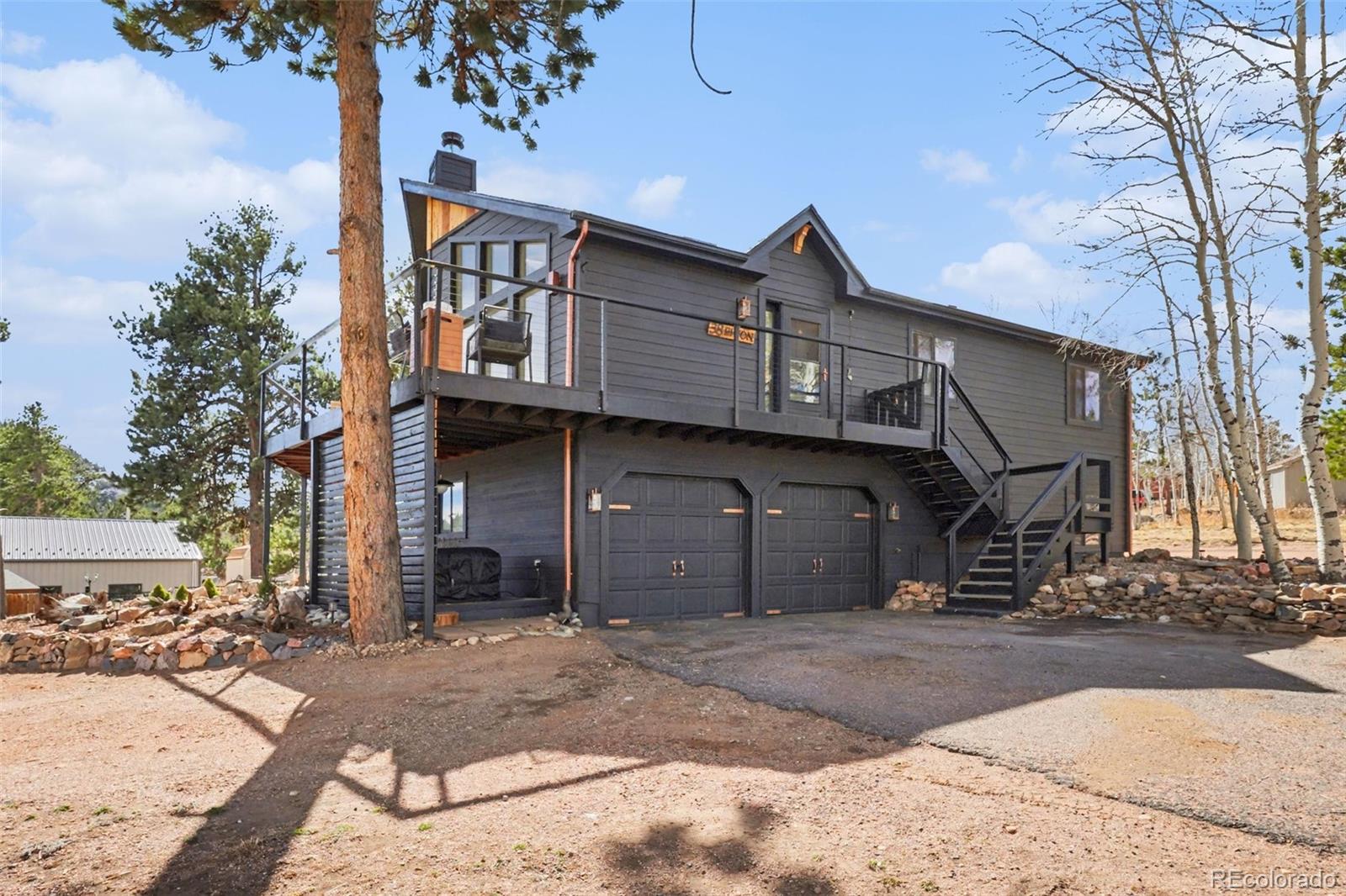 38 Pinon Road Bailey, CO 80421 - Photo 22 of 26 a front view of a house with a yard