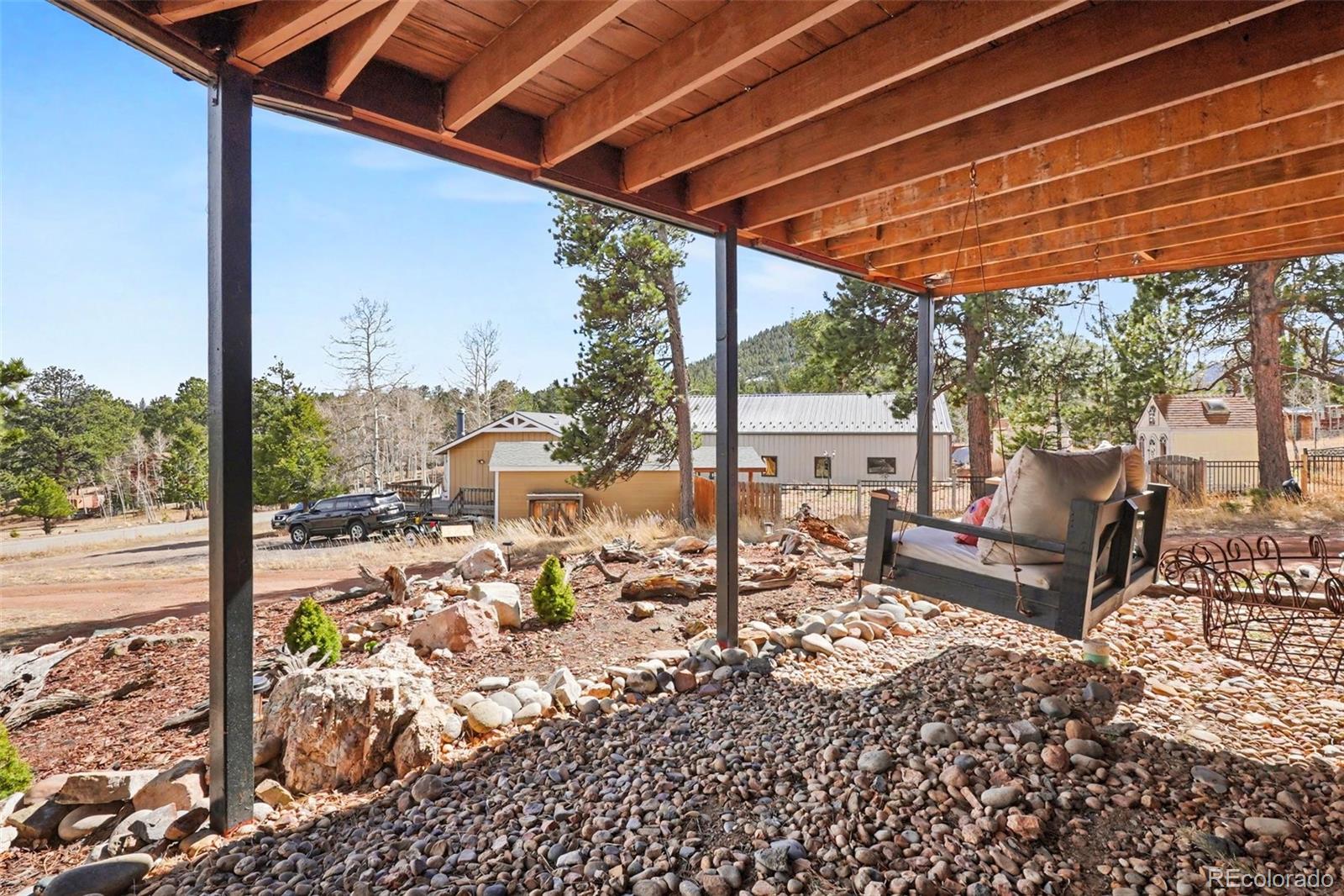 38 Pinon Road Bailey, CO 80421 - Photo 24 of 26 a view of a patio with table and chairs and wooden floor