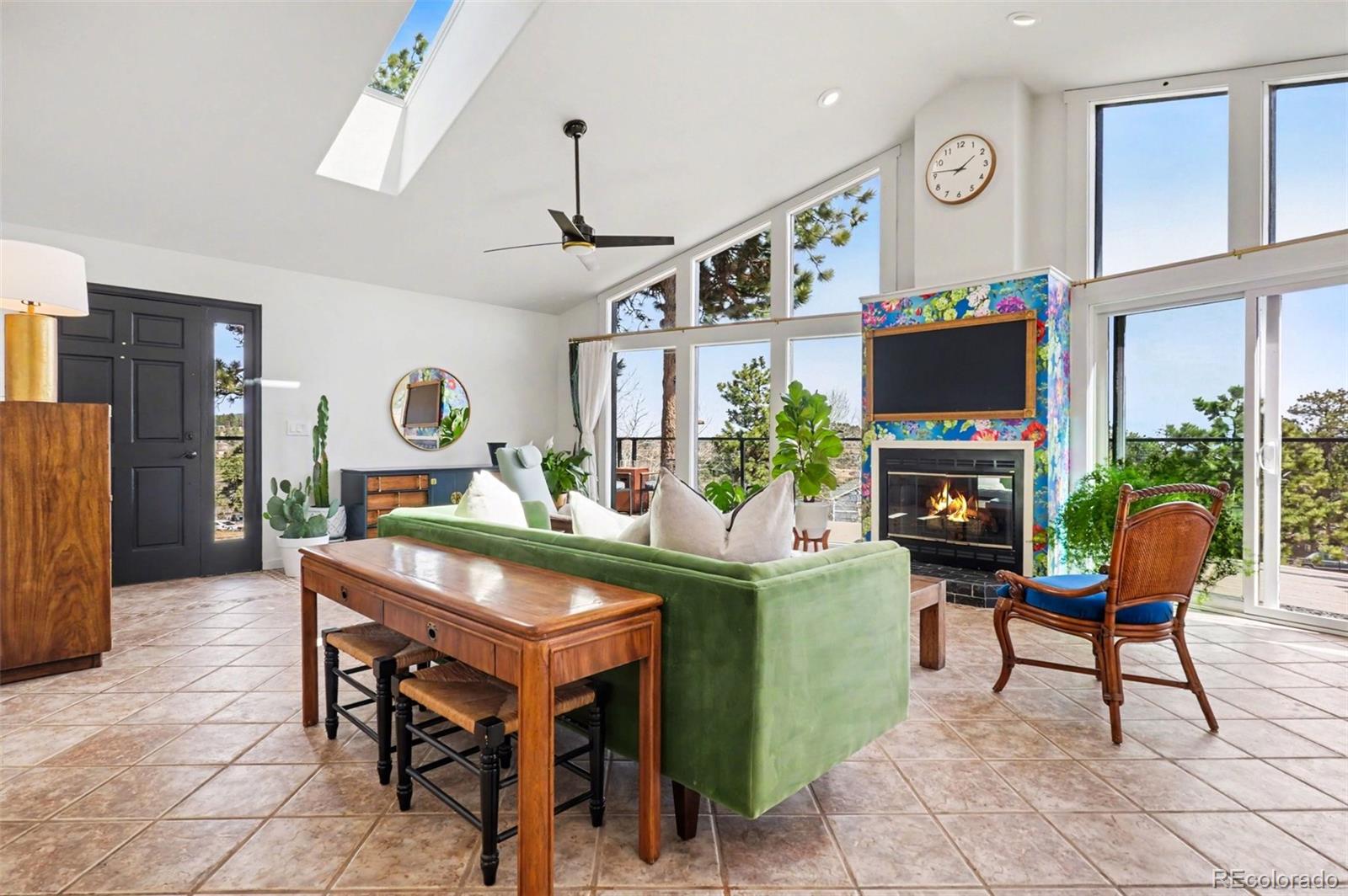 38 Pinon Road Bailey, CO 80421 - Photo 5 of 26 a living room with furniture a fireplace and a flat screen tv