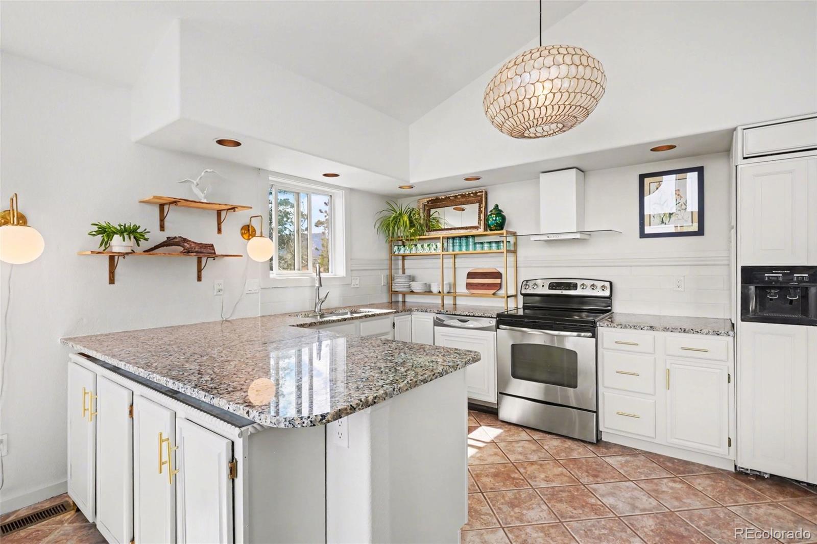 38 Pinon Road Bailey, CO 80421 - Photo 7 of 26 a kitchen with stainless steel appliances granite countertop a sink dishwasher stove and refrigerator