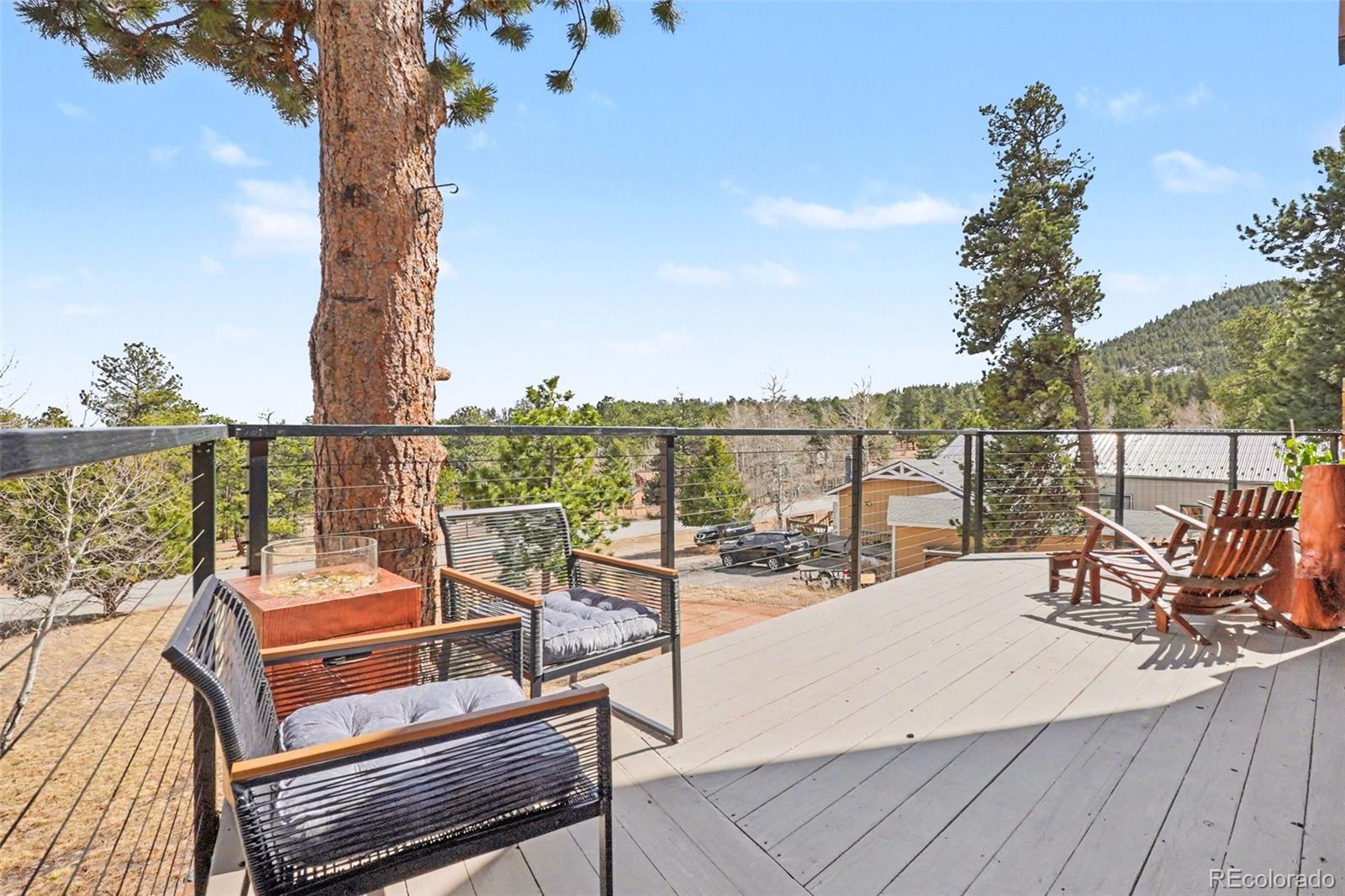 38 Pinon Road Bailey, CO 80421 - Photo 9 of 26 a view of a chairs and table on the terrace