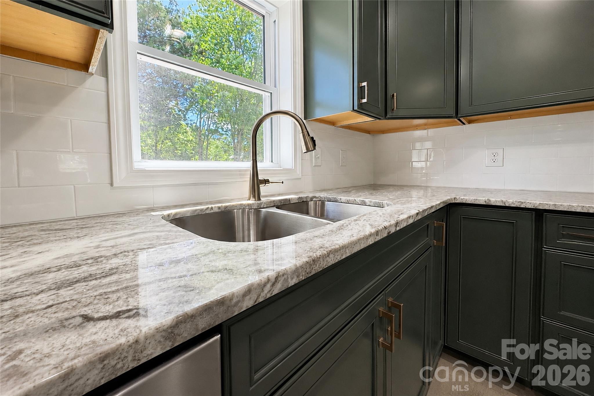 1403 Dudley Shoals Road Granite Falls, NC 28630 - Photo 4 of 34 a kitchen with granite countertop a sink and a window