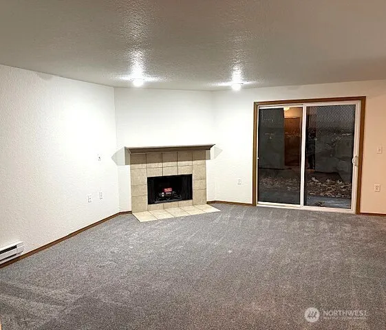 an empty room with a fireplace and window