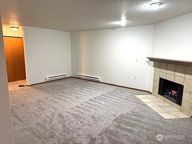 a view of empty room with a fireplace