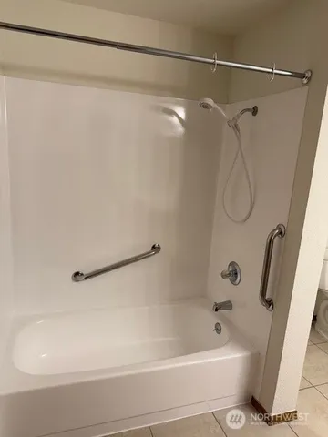 a bathroom with a shower and a bath tub