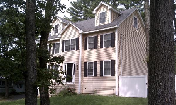 19 Ingersoll Road Billerica, MA 01821 - Photo 2 of 23 a front view of a house with a yard and garage