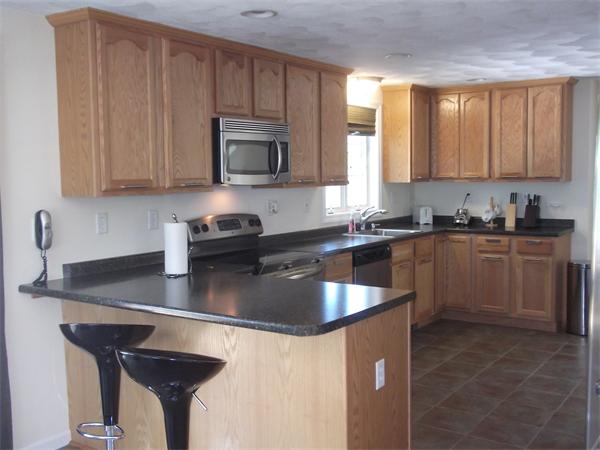 19 Ingersoll Road Billerica, MA 01821 - Photo 6 of 23 a kitchen with granite countertop a sink a stove and a microwave