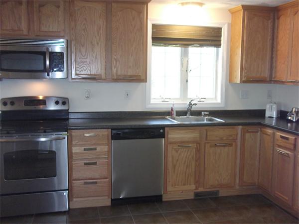 19 Ingersoll Road Billerica, MA 01821 - Photo 9 of 23 a kitchen with granite countertop white cabinets and stainless steel appliances