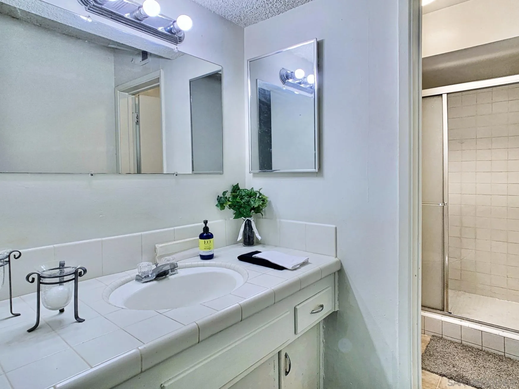 10111 Norte Mesa Drive Spring Valley, CA 91977 - Photo 18 of 29 a bathroom with a sink a vanity and a mirror