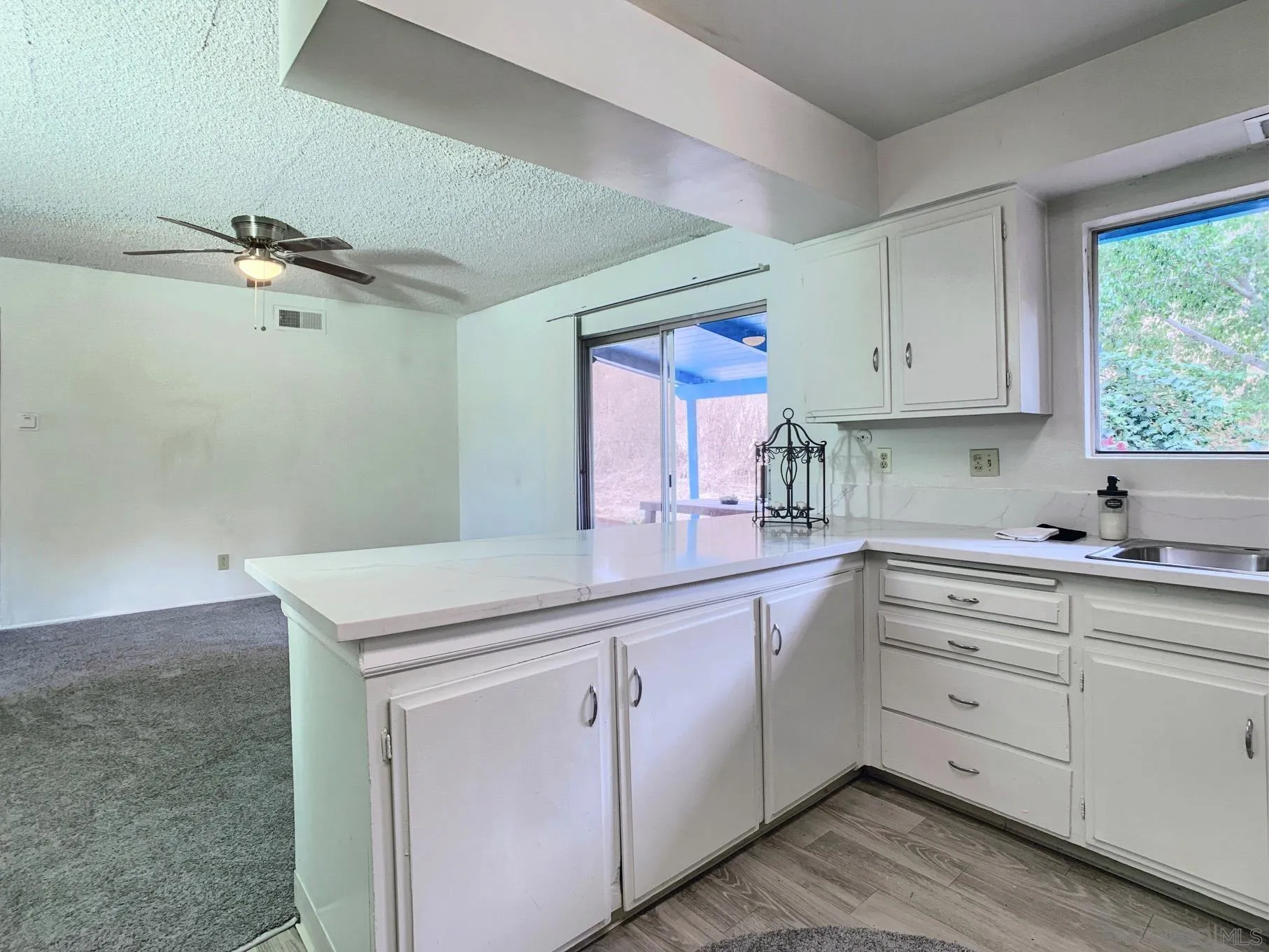 10111 Norte Mesa Drive Spring Valley, CA 91977 - Photo 8 of 29 a kitchen with white cabinets sink and window
