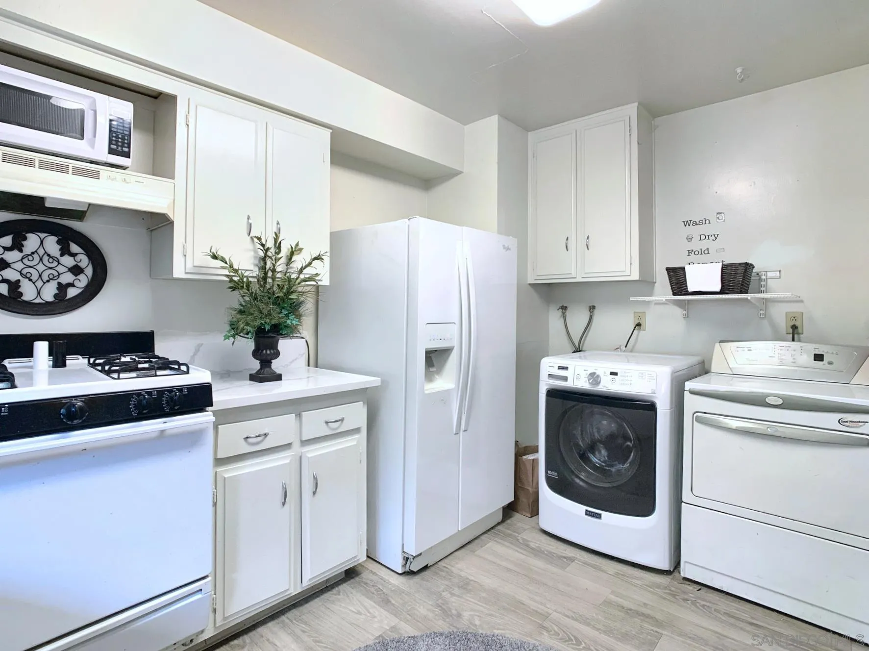10111 Norte Mesa Drive Spring Valley, CA 91977 - Photo 9 of 29 a kitchen with white cabinets and white appliances