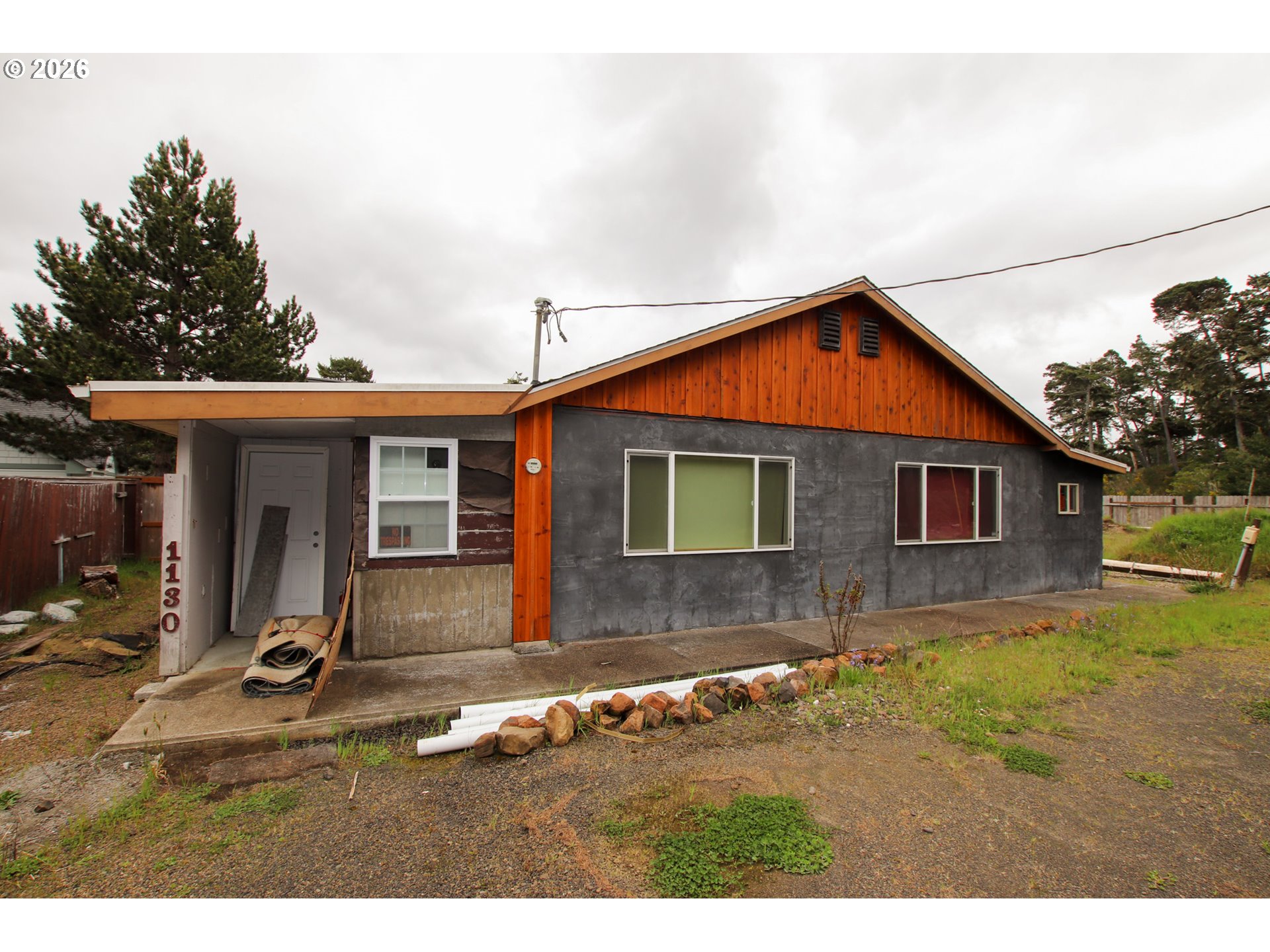 1120 Rhododendron Drive Florence, OR 97439 - Photo 1 of 6 a front view of a house with a yard