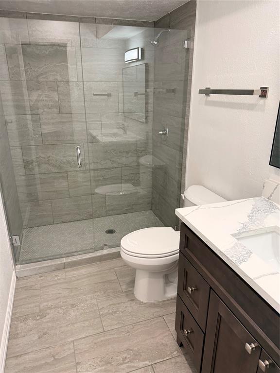 3933 Inwood Road, Unit 2023 Dallas, TX 75209 - Photo 15 of 24 a bathroom with a sink a toilet and shower