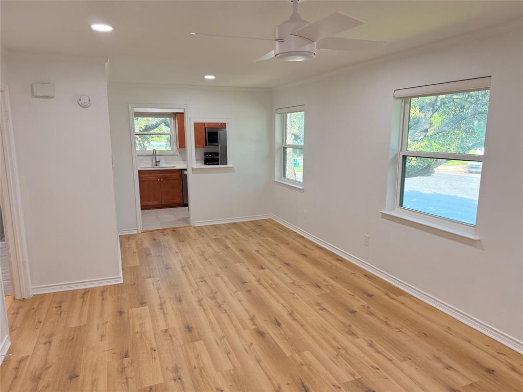3933 Inwood Road, Unit 2023 Dallas, TX 75209 - Photo 2 of 24 wooden floor in an empty room with a window