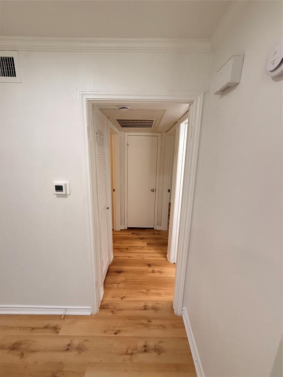 3933 Inwood Road, Unit 2023 Dallas, TX 75209 - Photo 10 of 24 a view of a hallway with wooden floor