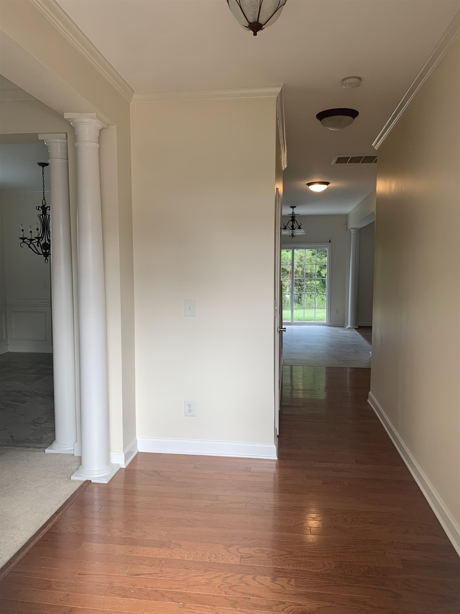 6316 Sparkling Brook Drive Raleigh, NC 27616 - Photo 12 of 44 an empty room with wooden floor and windows