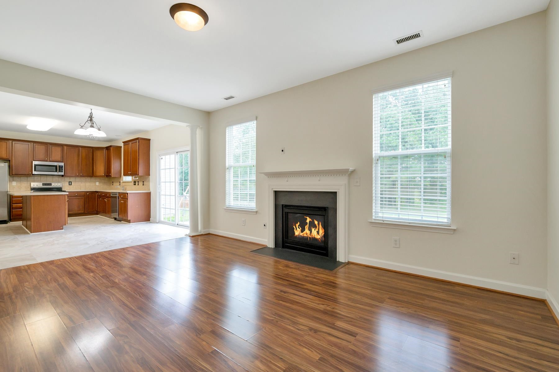 6316 Sparkling Brook Drive Raleigh, NC 27616 - Photo 17 of 44 a view of a livingroom with a fireplace wooden floor and a window