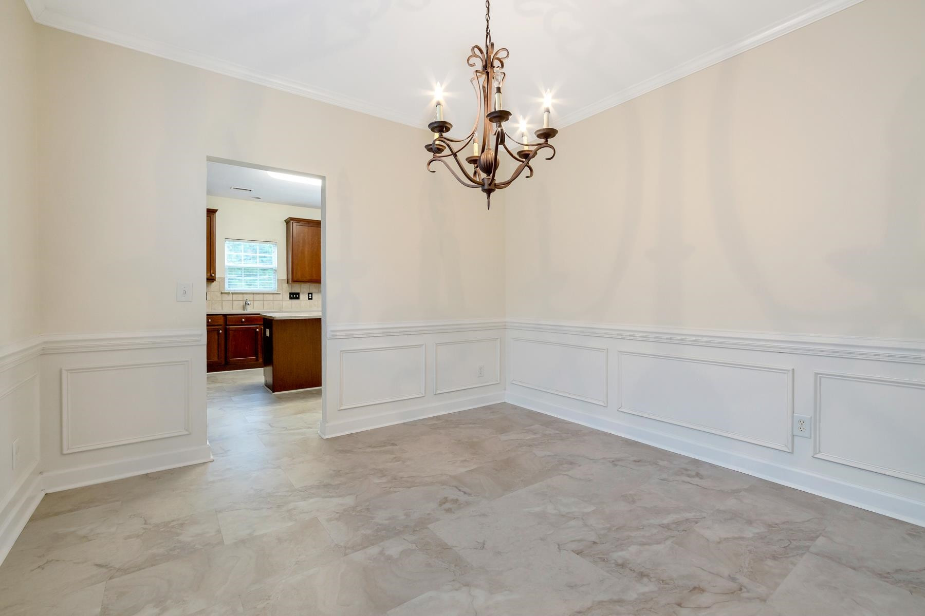 6316 Sparkling Brook Drive Raleigh, NC 27616 - Photo 22 of 44 wooden floor in an empty room with a chandelier