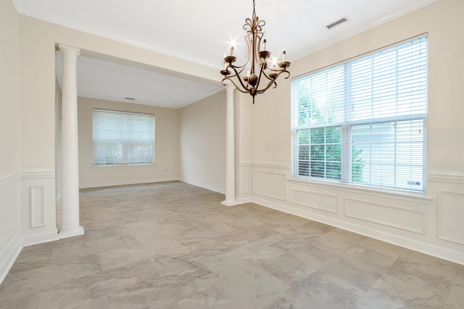 6316 Sparkling Brook Drive Raleigh, NC 27616 - Photo 23 of 44 an empty room with windows and chandelier
