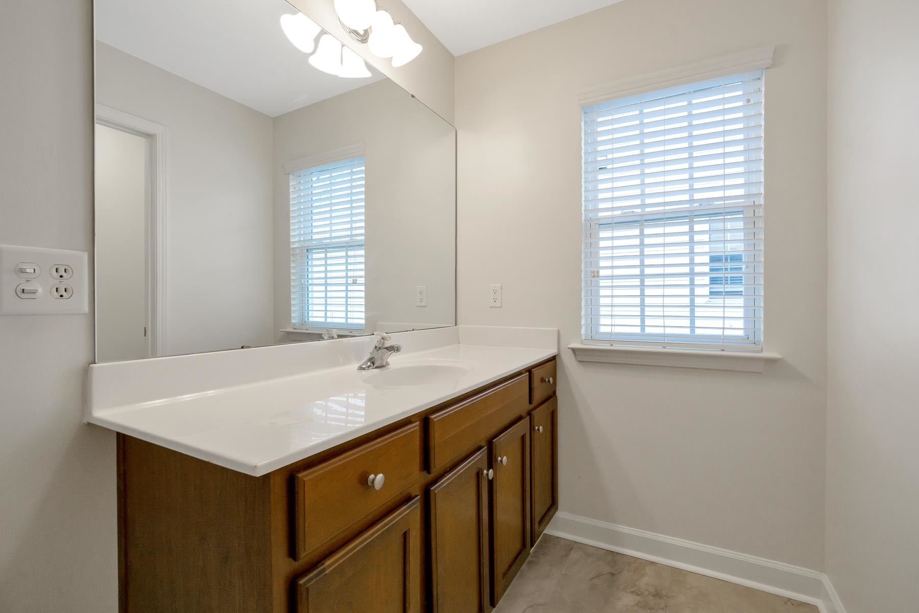6316 Sparkling Brook Drive Raleigh, NC 27616 - Photo 34 of 44 a bathroom with a sink vanity and a mirror
