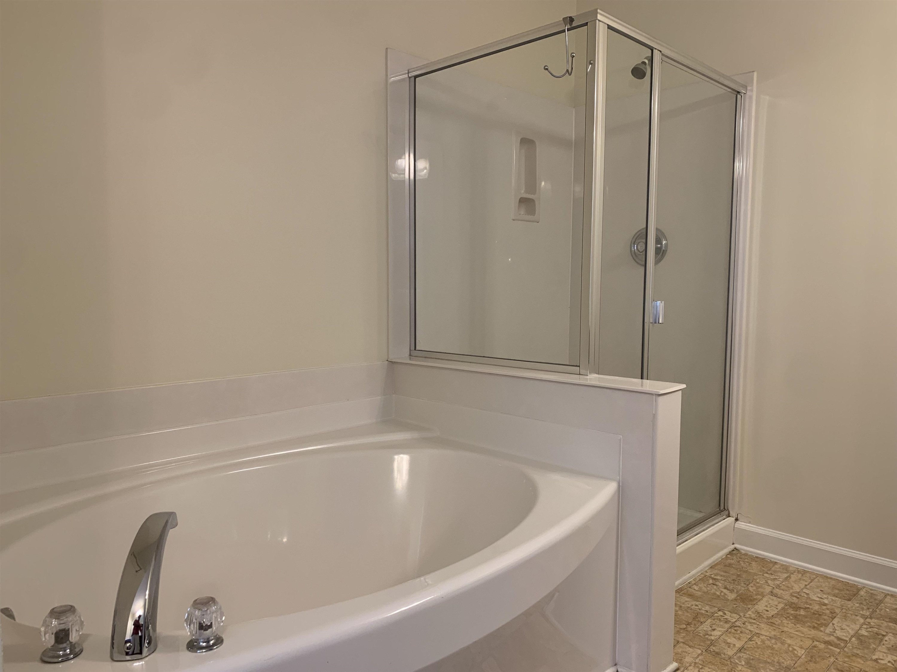 6316 Sparkling Brook Drive Raleigh, NC 27616 - Photo 37 of 44 a bathroom with a tub and shower