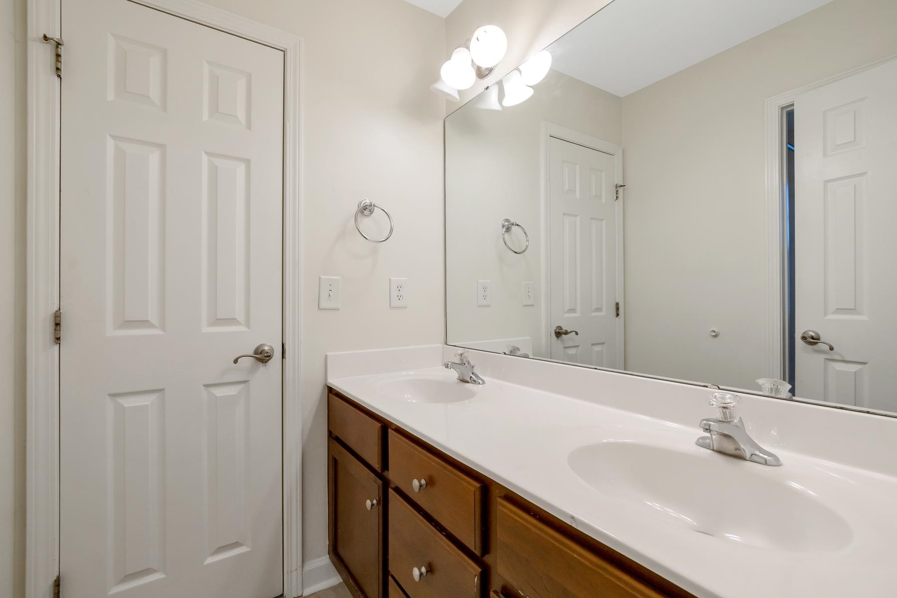 6316 Sparkling Brook Drive Raleigh, NC 27616 - Photo 40 of 44 a bathroom with double vanity sink a vanity and a mirror