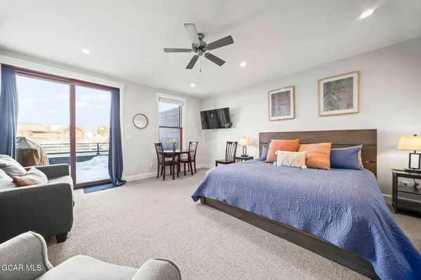a bedroom with a large bed couch and a window