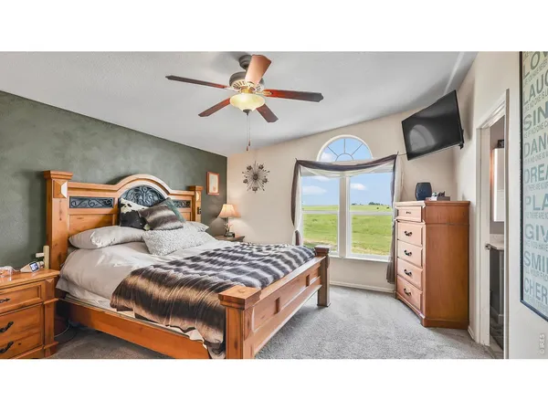 a bedroom with a bed and a television